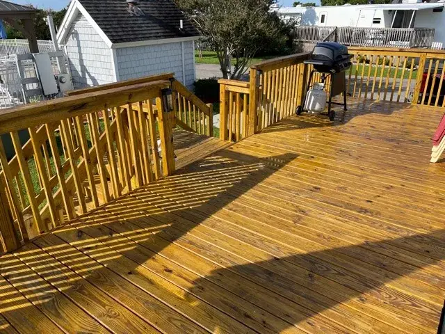 Freshly pressure washed wood deck and railings glowing in the sun