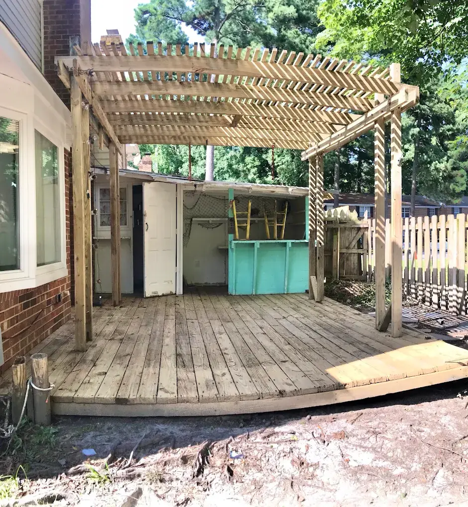 Backyard wood deck and pergola being pressure washed